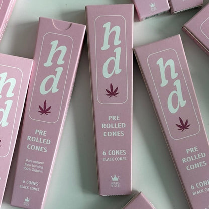 pink boxes of 'hd' pre-rolled cones on a light gray background