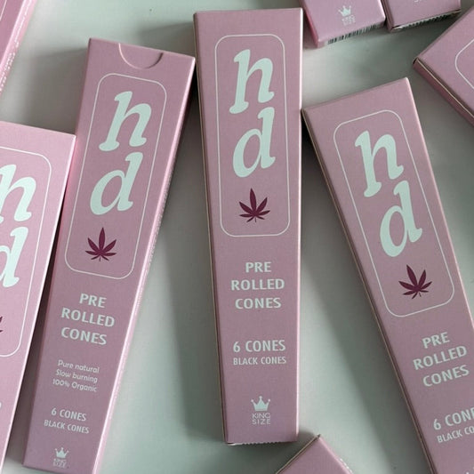 pink boxes of 'hd' pre-rolled cones on a light gray background