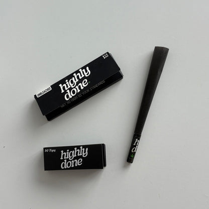 Two black makeup brushes with 'all day' and 'highly done' text on a light gray background